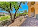 Backyard with an expansive view and mature trees, next to paver patio at 21 Via Visione # 101, Henderson, NV 89011