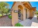 Close-up of a private gated entrance with an address plaque on a tan stucco home at 21 Via Visione # 101, Henderson, NV 89011