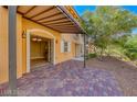 Paver patio with an open door that leads into the home, featuring nice landscaping at 21 Via Visione # 101, Henderson, NV 89011