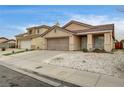 Inviting single-story home with a two-car garage, desert landscaping, and covered entryway at 2308 Avery Dr, Las Vegas, NV 89108