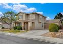 An angle view shows a charming two-story home with an attached garage, complemented by mature trees at 2374 Falsetto Ave, Henderson, NV 89052