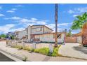 Two-story home with mixed brick and siding exterior and front yard needing revitalization at 3009 Merritt Ave, Las Vegas, NV 89102