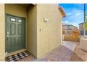 Home entryway with olive green door and paver walkway at 382 Scarlet Pine Ct, Henderson, NV 89044