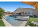 Resort-style backyard with a sparkling pool, spa, and covered patio area at 4310 Lailah Skye Ave, Las Vegas, NV 89141