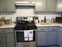 Well-lit kitchen with a stainless steel oven, light countertops, and grey cabinets at 432 Sellers Pl, Henderson, NV 89011