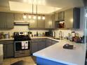 Updated kitchen with stainless steel appliances, overhead lighting, and light countertops at 432 Sellers Pl, Henderson, NV 89011