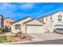 Beige single-story home with a two-car garage and minimal landscaping, under a bright blue sky at 4381 Coyote Crest Ct, Las Vegas, NV 89147