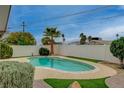 Relax in the backyard oasis with a private pool, patio and lush green landscaping at 4678 San Benito St, Las Vegas, NV 89121