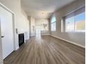 Bright living room with a fireplace and wood floors flowing into the open-concept kitchen at 5263 Shasta Lake Way, Las Vegas, NV 89118