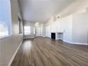 Spacious living room with wood floors, fireplace, and large windows for natural light at 5263 Shasta Lake Way, Las Vegas, NV 89118
