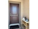 Stylish front door with modern hardware, complementing the home's neutral exterior at 5555 E San Pietro Dr, Pahrump, NV 89061