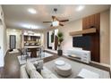 Staged living room with modern decor, open floor plan, and a view of the kitchen at 56 E Serene Ave # 306, Las Vegas, NV 89123