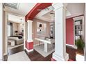 Staged office with built-in bookshelves and decorative columns, adjacent to a bedroom at 56 E Serene Ave # 306, Las Vegas, NV 89123