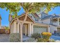 Inviting two-story home with a covered entryway, low maintenance front yard, and a two-car garage at 5916 Sierra Cliff St, North Las Vegas, NV 89031