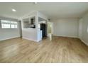 Open-concept living area with laminate wood flooring and a view of the kitchen at 604 N Minnesota St, Las Vegas, NV 89107