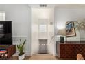 Bright entryway featuring white walls and wood floors creating a clean, modern welcome at 6809 Cobre Azul # 201, Las Vegas, NV 89108