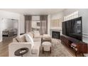 Inviting living room featuring a cozy sofa, stone fireplace, and a mounted TV at 6809 Cobre Azul # 201, Las Vegas, NV 89108