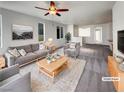 Bright living room featuring modern furniture, a ceiling fan, and neutral decor at 7024 Whispering Falls Dr, North Las Vegas, NV 89084