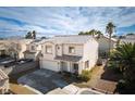 Charming two-story home showcasing a well-maintained exterior, a two-car garage and desert landscaping at 7820 Esteem St, Las Vegas, NV 89131