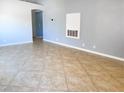 Spacious open concept living area with neutral paint, tile flooring and lots of natural light at 8032 Astrology Ct # 201, Las Vegas, NV 89128