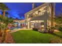 A beautifully landscaped backyard features a pool, spa, and lush greenery with a covered patio at 8032 Marbella Cir, Las Vegas, NV 89128