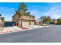 A two-story home with a three-car garage and a well-kept lawn on a corner lot at 8102 Villa De La Playa St, Las Vegas, NV 89131