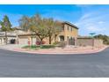 A two-story house on a corner lot featuring a well-maintained lawn and a three-car garage at 8102 Villa De La Playa St, Las Vegas, NV 89131