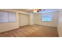Living room featuring neutral paint, carpet flooring, ceiling fan, and natural light at 8120 Finch Feather St, Las Vegas, NV 89143