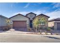 Charming single-story home featuring desert landscaping, brick driveway, and a stone-accented facade on a clear day at 827 Klamath Springs St, Henderson, NV 89011