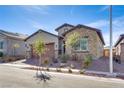 Charming single-story home featuring desert landscaping, brick driveway, and a stone-accented facade on a clear day at 827 Klamath Springs St, Henderson, NV 89011