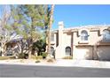 Charming two-story townhome with a private garage and well-maintained landscaping at 9672 Gunsmith Dr, Las Vegas, NV 89123