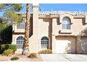 Inviting two-story home with arched windows and a well-manicured front yard at 9672 Gunsmith Dr, Las Vegas, NV 89123