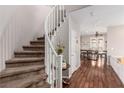 Welcoming foyer featuring a winding staircase and elegant hardwood floors at 11237 Gallery Echo St, Las Vegas, NV 89141