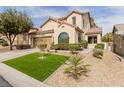 Inviting home showcasing a tidy lawn, xeriscaping, and a spacious two-car garage at 11237 Gallery Echo St, Las Vegas, NV 89141