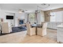 Open-concept living area featuring a cozy fireplace, dining area, and ample natural light at 11820 Calle De Sol Dr, Las Vegas, NV 89138