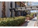 The exterior features a pergola-covered walkway and mature landscaping for a serene setting at 1390 Vegas Valley Dr # 25, Las Vegas, NV 89169