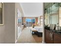 Elegant hotel suite with a king-size bed, desk, and views of the city from a private balcony at 145 E Harmon Ave # 2917, Las Vegas, NV 89109