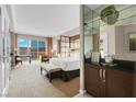 Luxurious hotel room featuring a king bed, workspace, and a balcony with expansive city views at 145 E Harmon Ave # 2917, Las Vegas, NV 89109