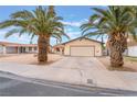 Charming single-story home with a well-manicured yard and mature palm trees at 212 N Torrey Pines Dr, Las Vegas, NV 89107