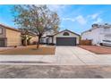 Attractive single-story home showcasing a two-car garage and easy-care front yard at 2120 Maple Springs St, Henderson, NV 89002