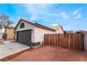 Side view of a single story home with a two-car garage and a privacy fence at 2120 Maple Springs St, Henderson, NV 89002
