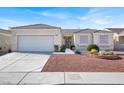 Inviting single-story home features a manicured front yard, complemented by an attached two-car garage at 3015 Extravagant Ave, North Las Vegas, NV 89031