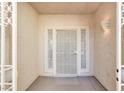 Covered front entrance showcasing a security screen door and exterior lighting fixture at 3015 Extravagant Ave, North Las Vegas, NV 89031