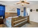 Bedroom featuring wood-frame bed, carpeted floor, and ceiling fan at 4606 Engage St, North Las Vegas, NV 89031