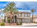 Beautiful two-story home featuring a three-car garage, desert landscaping and palm trees at 4679 El Camino Cabos Dr, Las Vegas, NV 89147