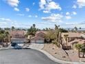 This home features a three-car garage, a front yard, and a driveway in a beautiful neighborhood at 5 Rampart Ct, Henderson, NV 89074