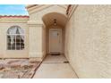 Inviting covered entryway to the front door with sidelight and decorative overhead light fixture at 5033 Chambliss Dr, Las Vegas, NV 89130