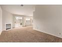 Bright living room with carpet, a fireplace, and a sliding glass door to the backyard at 5033 Chambliss Dr, Las Vegas, NV 89130