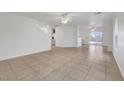 Spacious living room featuring tile flooring, ceiling fans and lots of natural light at 5044 Whistling Acres Ave, Las Vegas, NV 89131