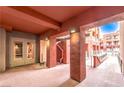 Entrance way with exposed rafters, beams, cement flooring and walls and door leading to elevator at 51 E Agate Ave # 205, Las Vegas, NV 89123